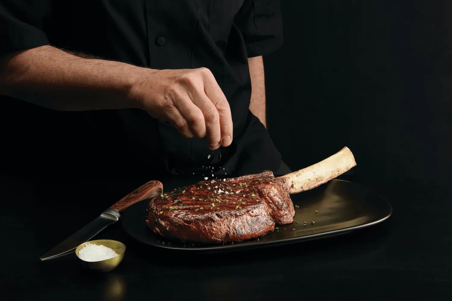 Discover Our Story - Steak grilling over wood fire